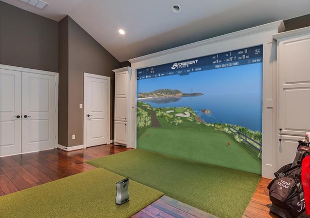 An indoor golf simulator setup of the Foresight brand