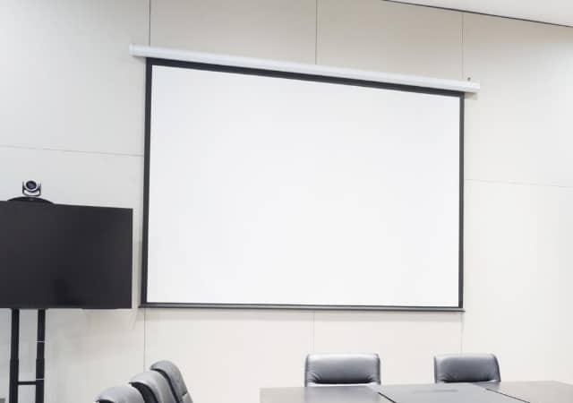 Projection screen mounted on the wall of a room