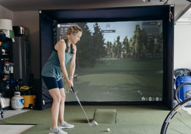Playing on a golf simulator inside a room